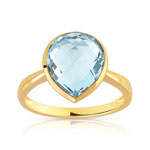 Bague or 750 jaune topaze bleue trait&eacute;e