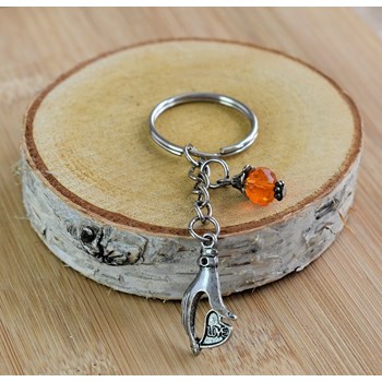 Hand keyring holding a silver love heart and orange faceted pearl