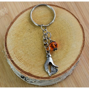 Hand keyring holding a silver love heart and orange faceted pearl