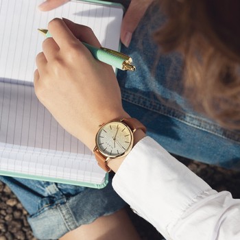 Women's gold watch with brown synthetic bracelet