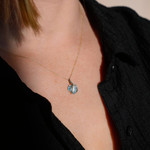 375 two-tone gold pendant with a treated blue topaz in the shape of a heart - worn view 1