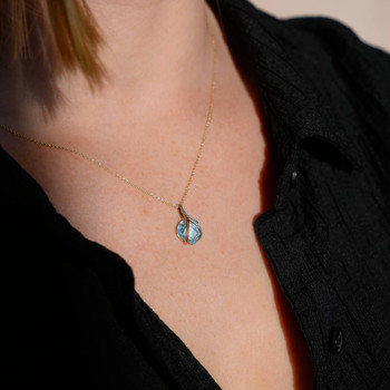 375 two-tone gold pendant with a treated blue topaz in the shape of a heart