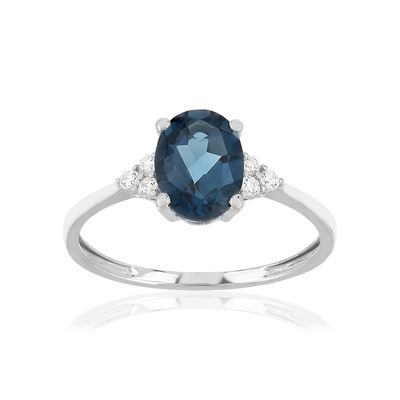 Bague or 375 blanc topaze bleue traitée et zirconias