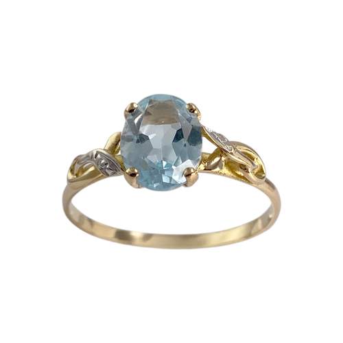 Pre-owned 14K two-tone gold ring with a treated blue topaz