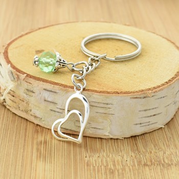 Zilveren sleutelhanger met hart en groene facetparel