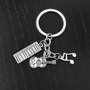 Sleutelhanger met muziekthema artiest noten gitaar piano zilver