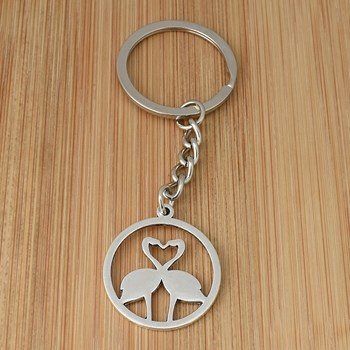Keychain with pink flamingos forming a heart in a silver circle