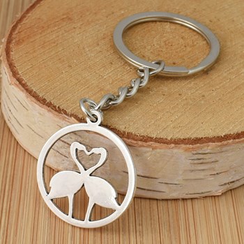 Keychain with pink flamingos forming a heart in a silver circle
